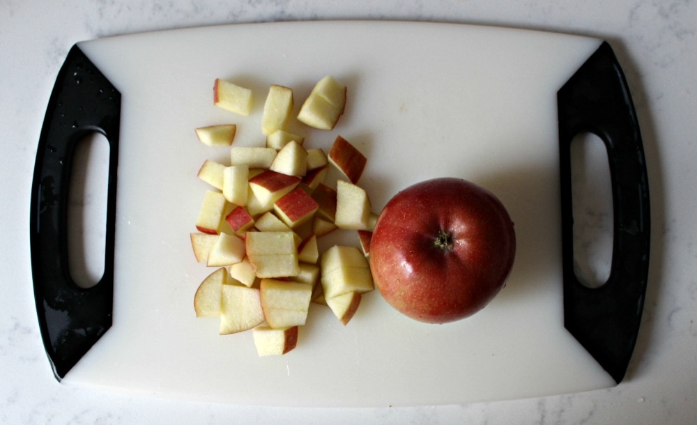Chopped diced apples on a cutting board.