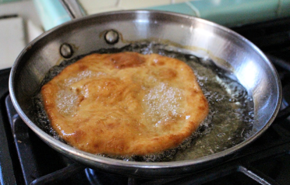 Buñuelos frying in the frying pan. 
