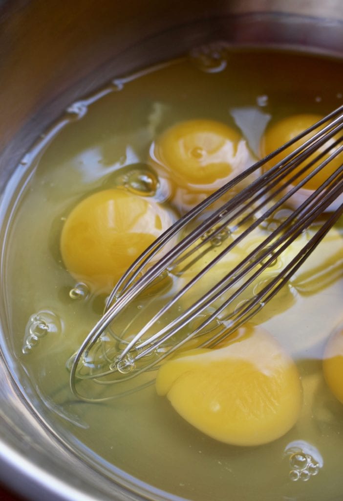 Bowl with eggs waiting to be whisk that is by the side.