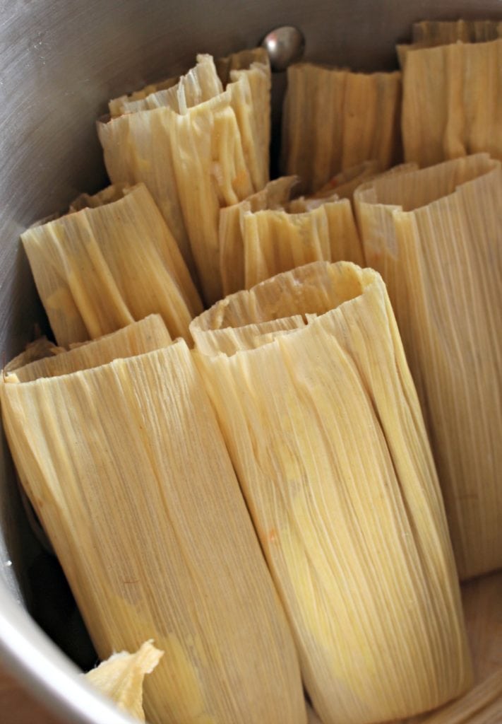 Tamales assembled and standing up in a stock pot. 