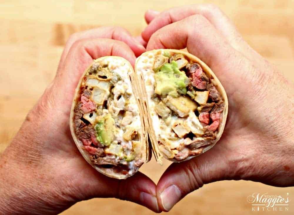Hands making a heat shape with the California Burrito inside the heart.