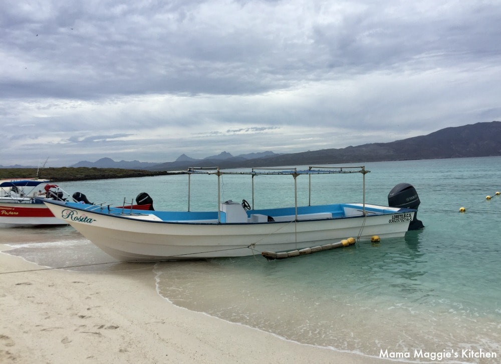 A boat in crystal clear water in Isla Coronado, Baja California Sur.