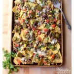 Carne Asada Nachos is a tasty, delicious, and indulgent appetizer loved by foodies everywhere. Try this easy sheet pan recipe for game day or your next party. By Mama Maggie's Kitchen
