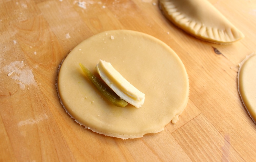 Cheese and pickled jalapenos placed in the center of pie dough circle.
