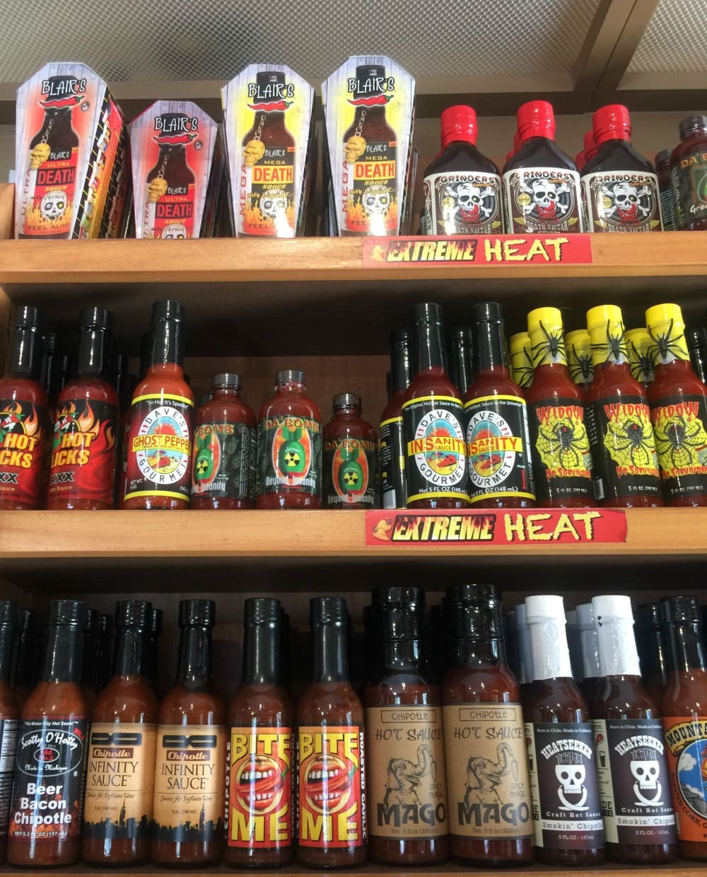 Extreme hot sauce bottles on display at a store. 
