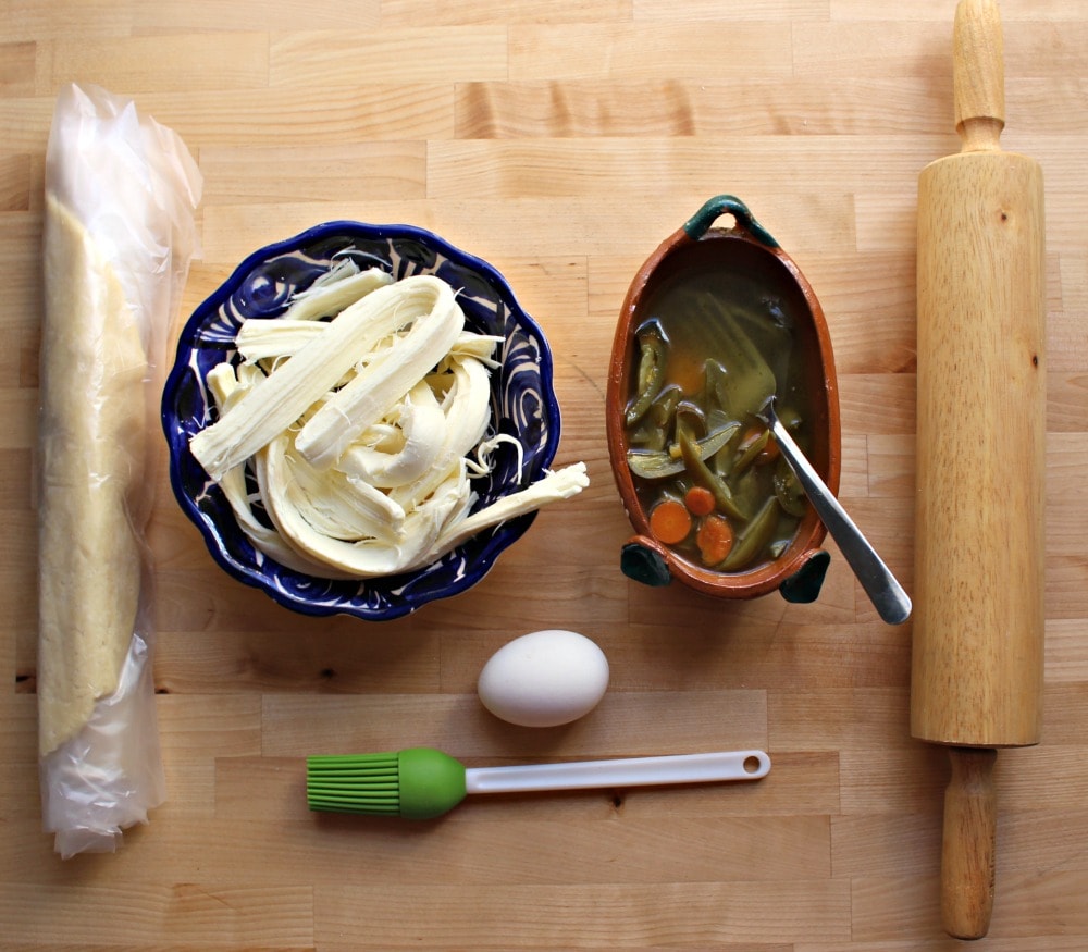 Ingredients for Empanadas de Queso on a wooden surface. 