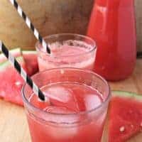 Two glasses of Watermelon Agua Fresca with black and white straws.