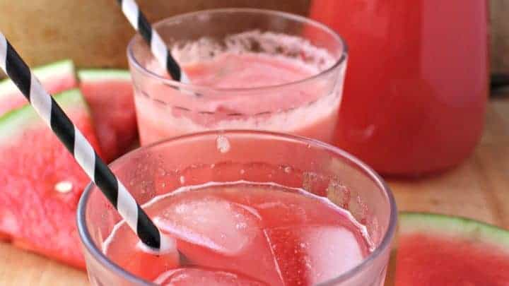 Two glasses of Watermelon Agua Fresca with black and white straws.