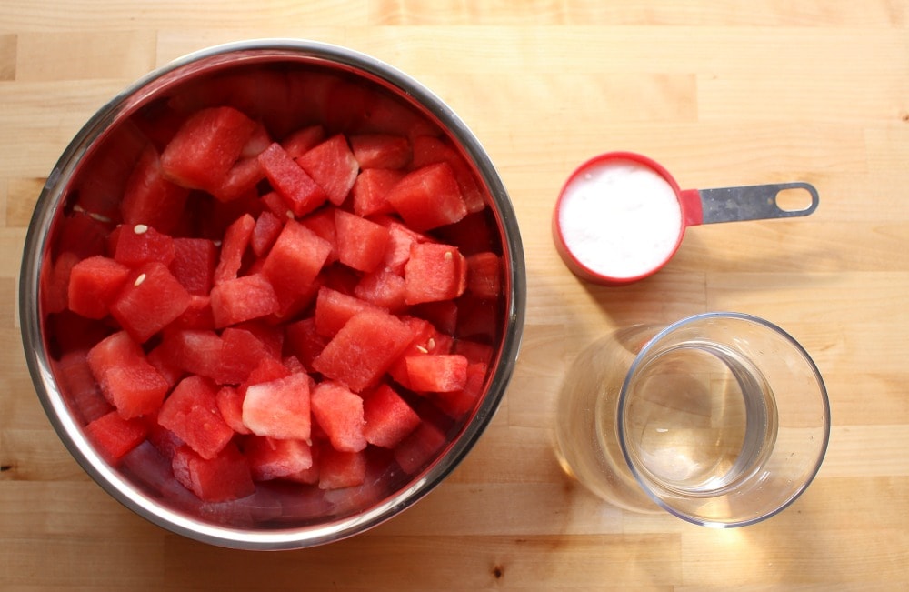 Ingredients for watermelon agua fresca on a wooden surface.