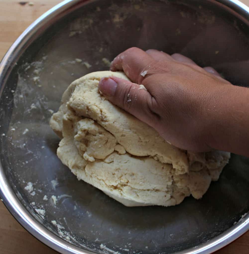 Hand kneading the corn masa dough.