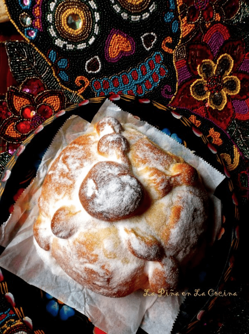 A picture of pan de muerto next to a drawing of a sugar skull.