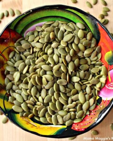 Pepitas pumpkin seeds in a decorative and colorful bowl.