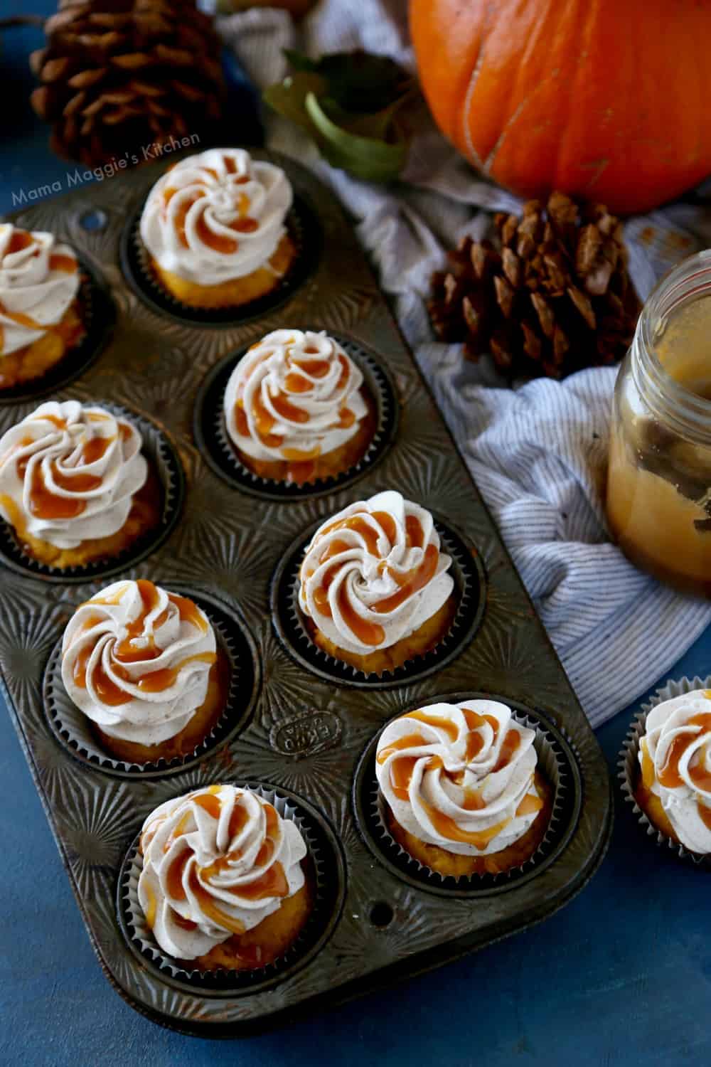 Pumpkin cupcakes drizzled with cajeta in a cupcake pan. 