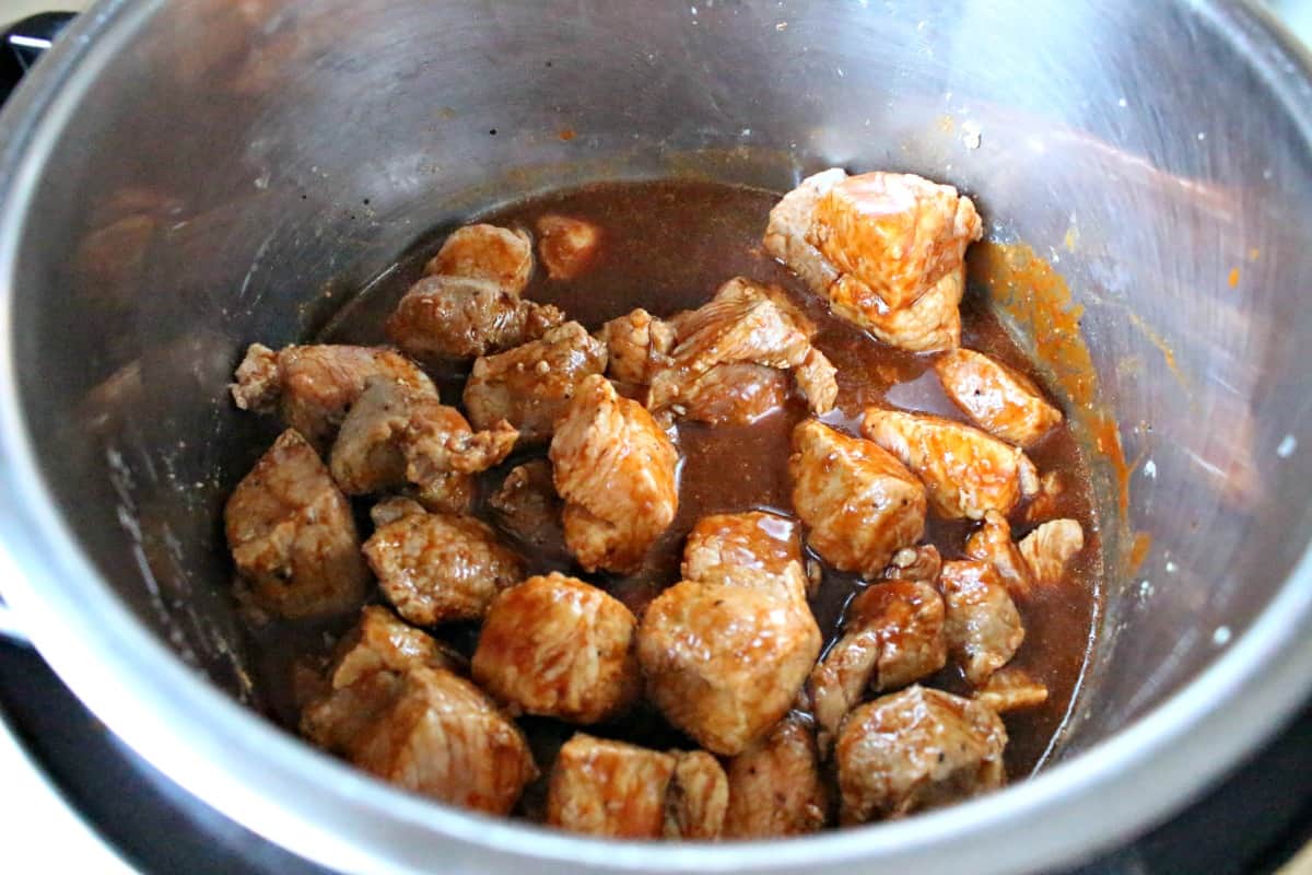 Chile coloardo cooking with the pork meat inside the instant pot. 