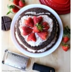 Mexican chocolate cake decorated with fresh strawberries.