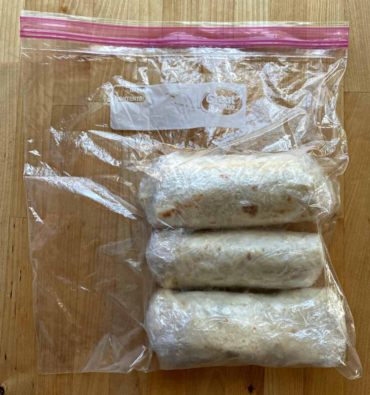Frozen burritos in a plastic, sealable bag. 