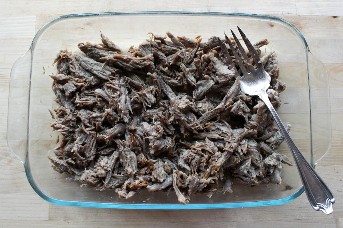 Shredded beef in a dish with a fork.