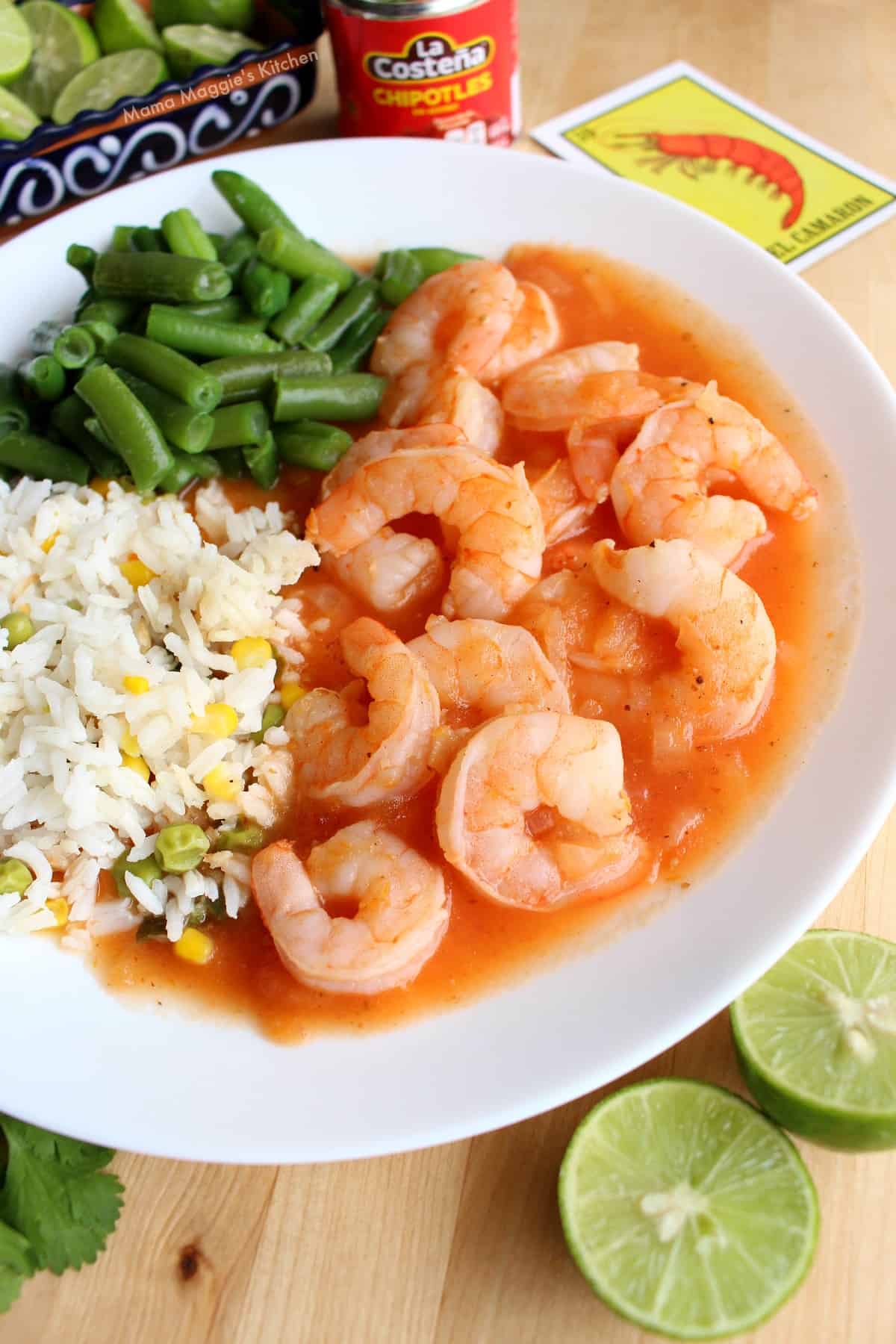 Camarones Enchipotlados served with green beans and white rice.