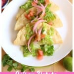 Crispy Potato Tacos Dorados on a white plate topped with lettuce and pickled red onions.