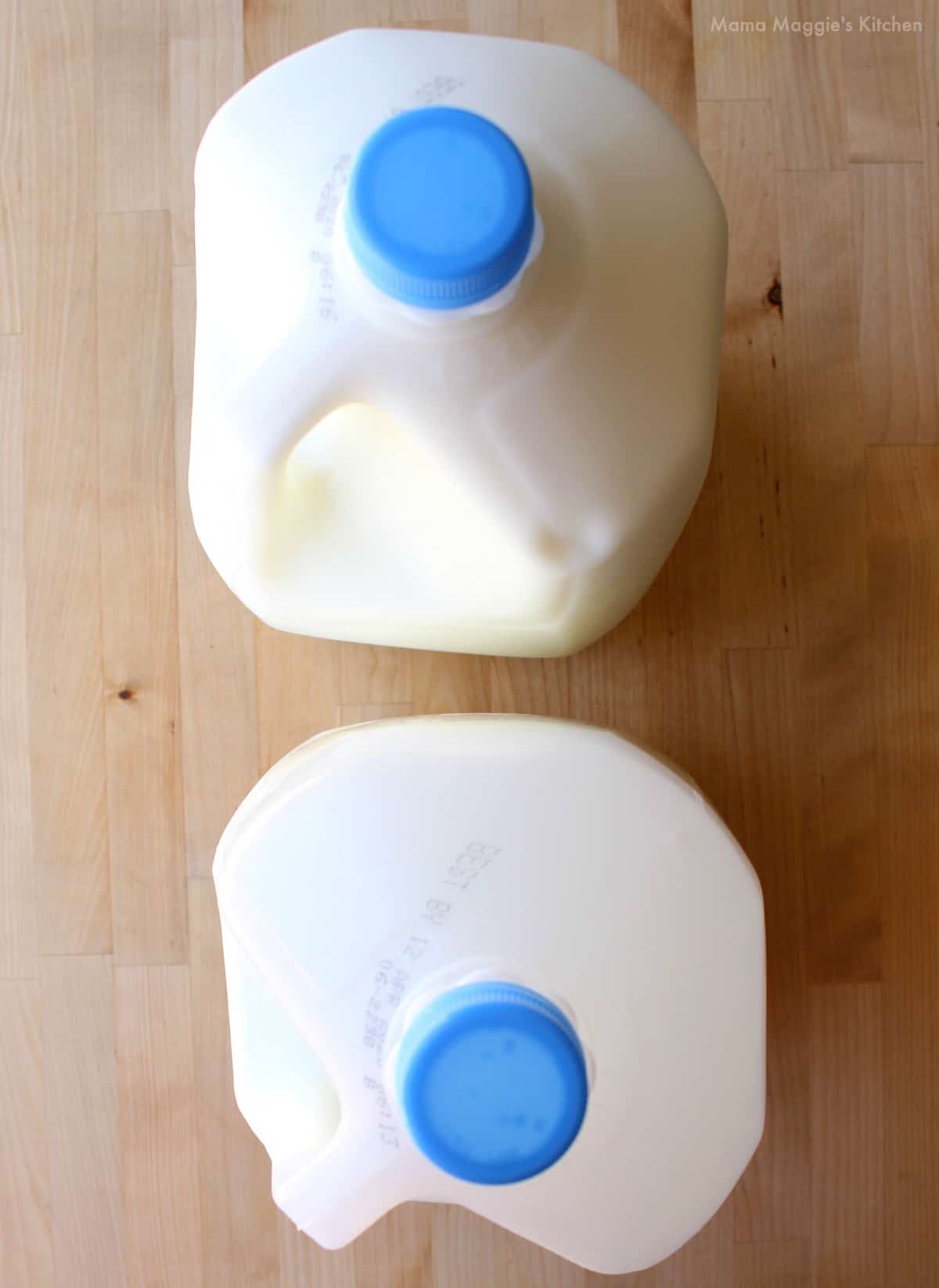 An overhead picture of two gallons of milk.