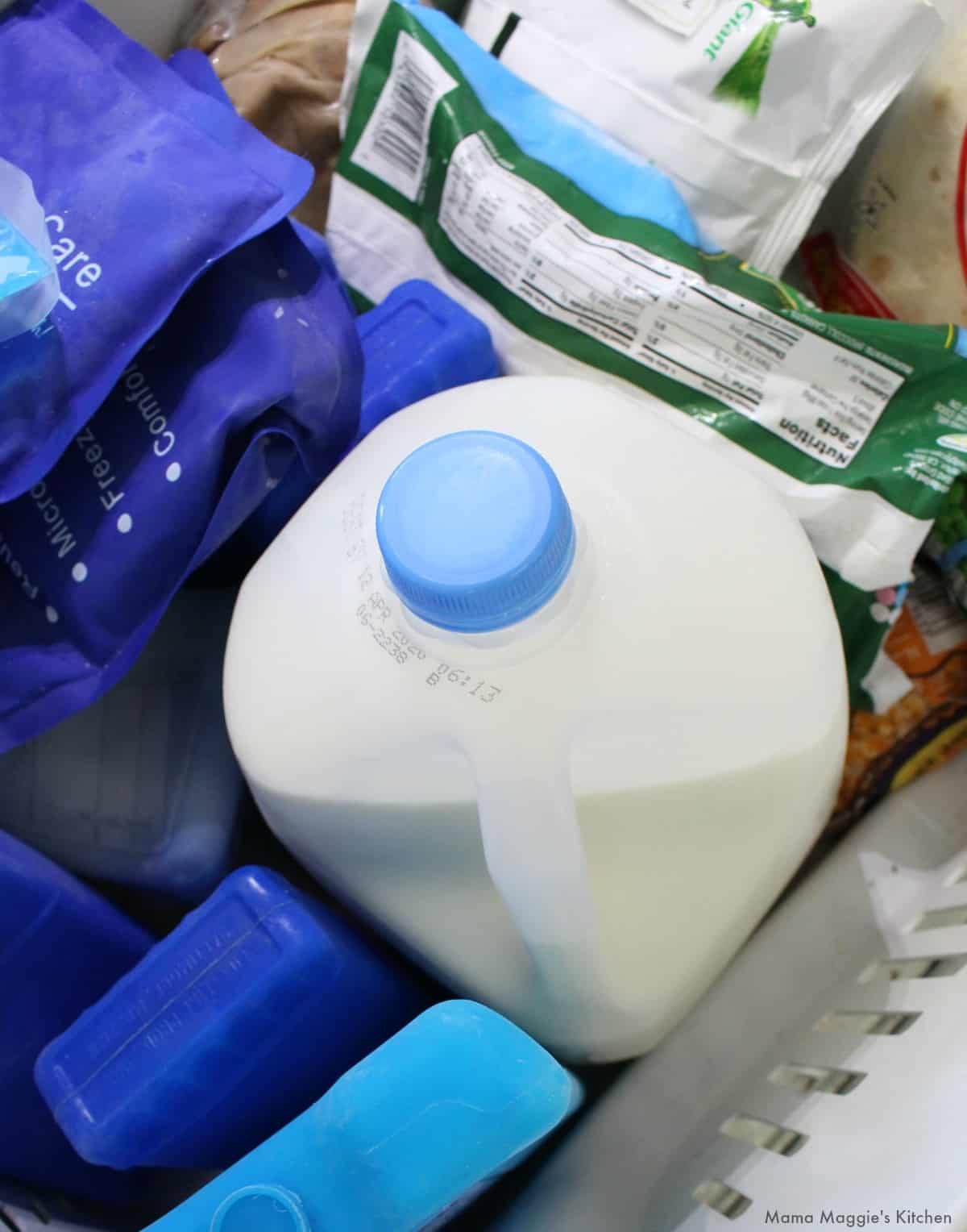 A gallon of milk in a freezer.
