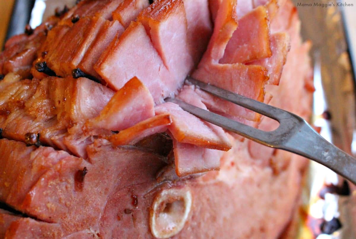 A fork showing the slices of a cooked Piloncillo Chipotle Ham.