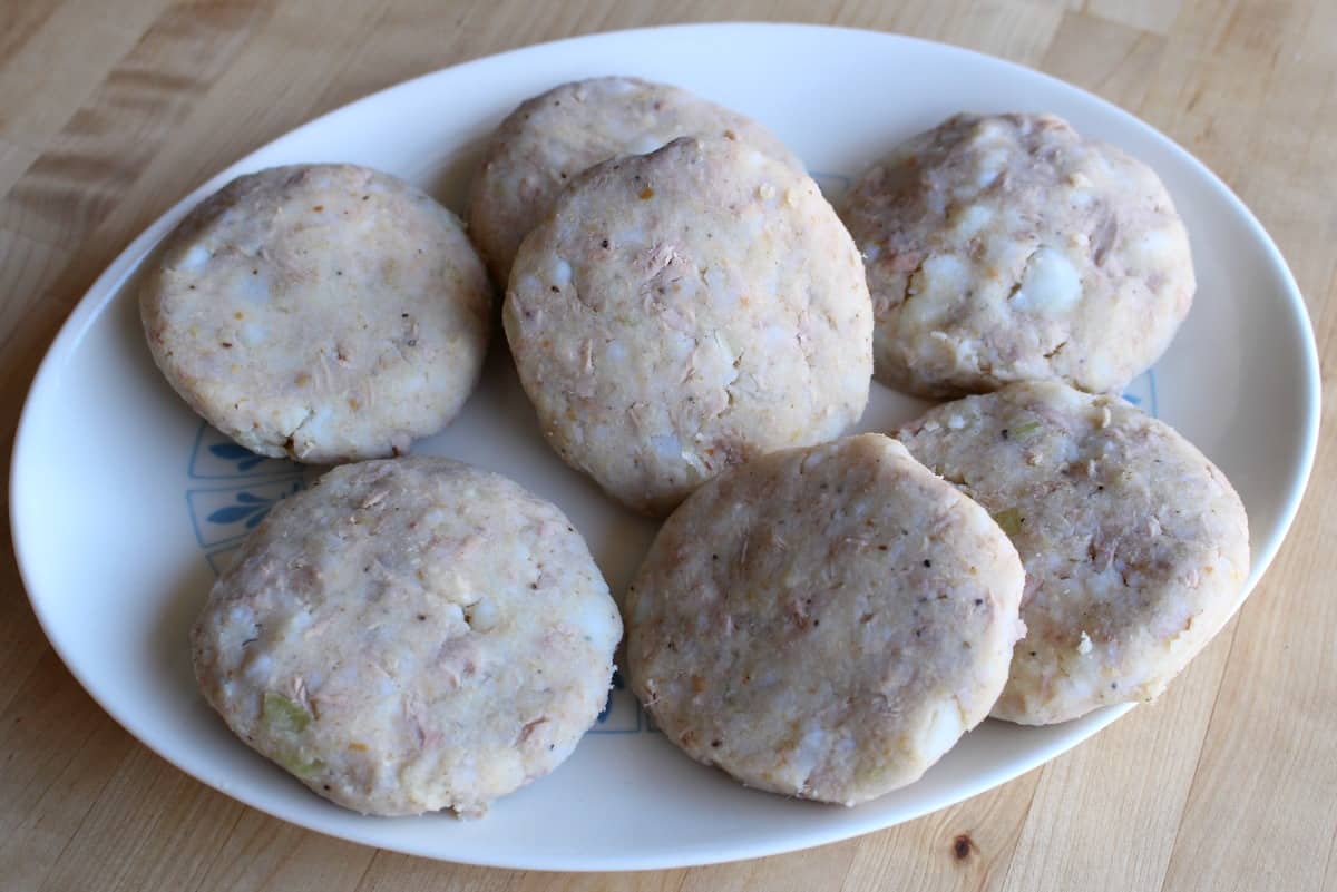 Tuna Potato Patties uncooked and on a white plate.