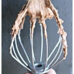 A mixer attachment covered in Abuelita Chocolate Frosting.