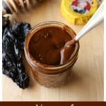 Mole sauce in a jar with a spoon inside.
