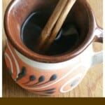 Café de la Olla served with a cinnamon stick in a decorative Mexican mug.