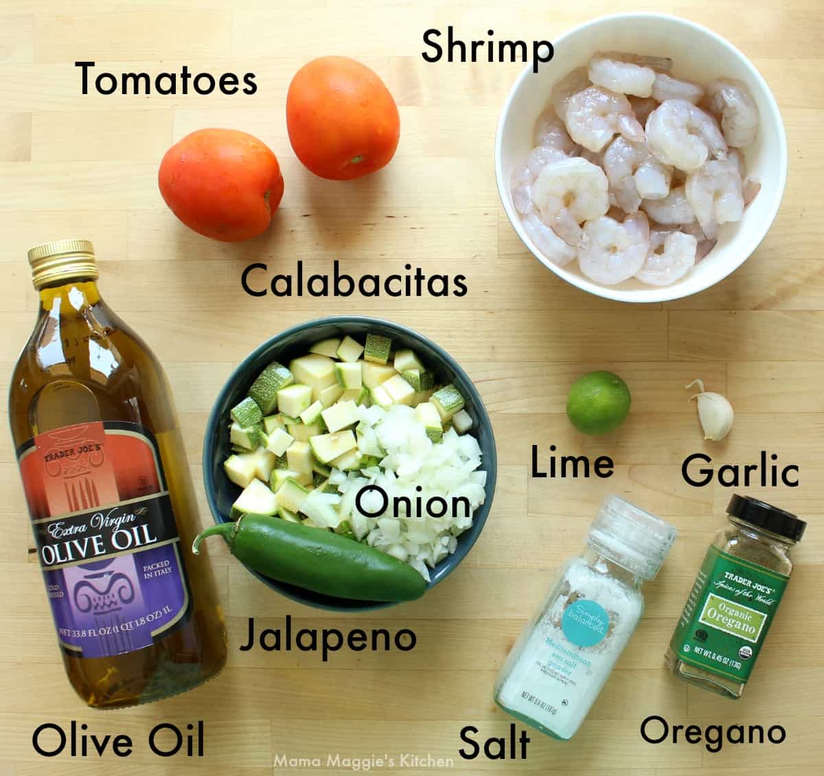 Ingredients for camarones con calabacitas laid out on a wooden surface.