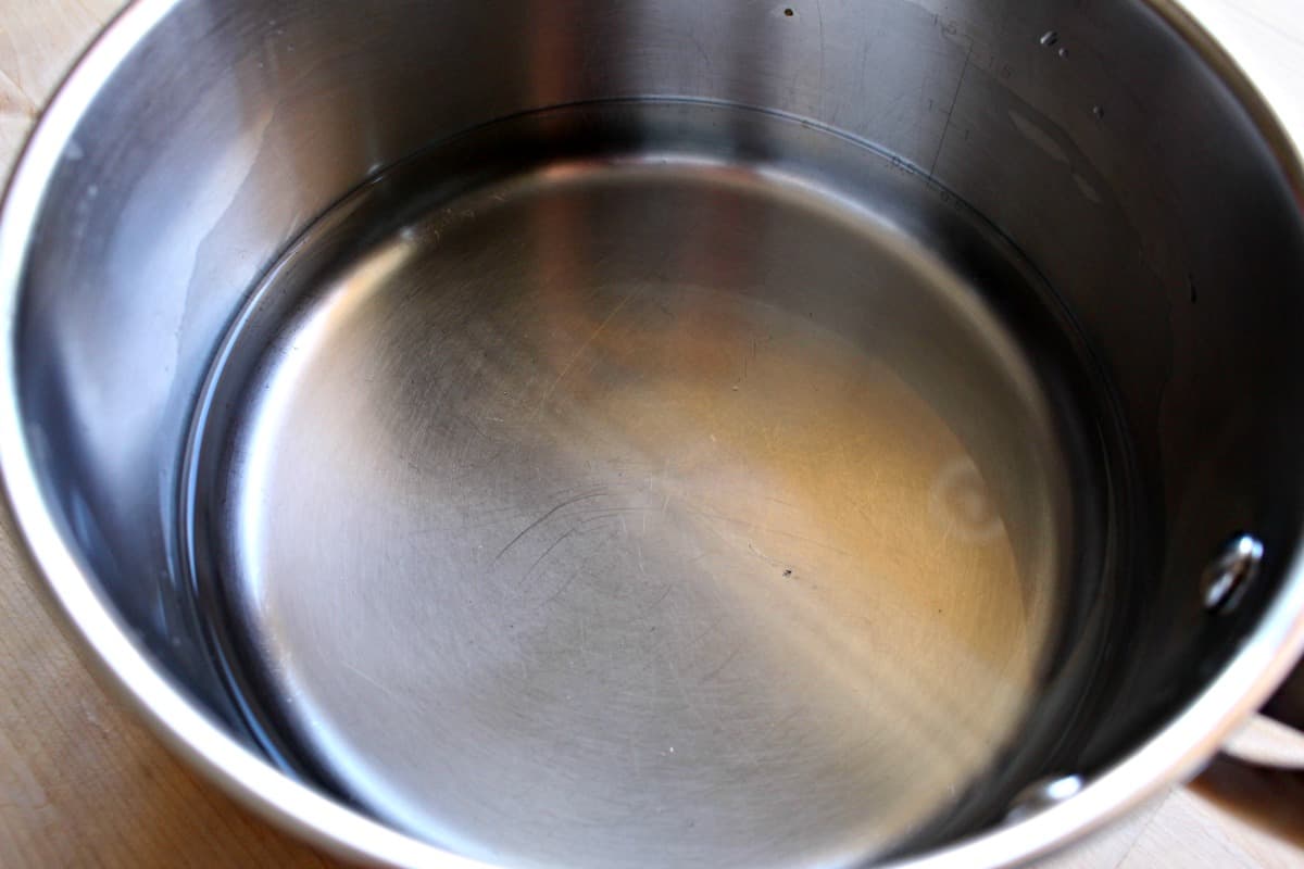 A metal stock pot with water inside.