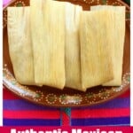A colorful table rug with a Mexican plate full of tamales.