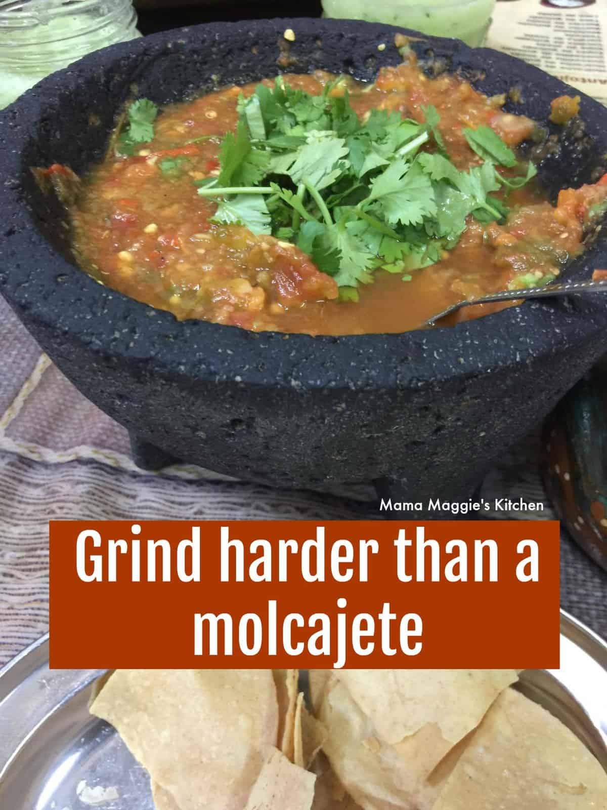 A picture of a molcajete with salsa and topped with cilantro.