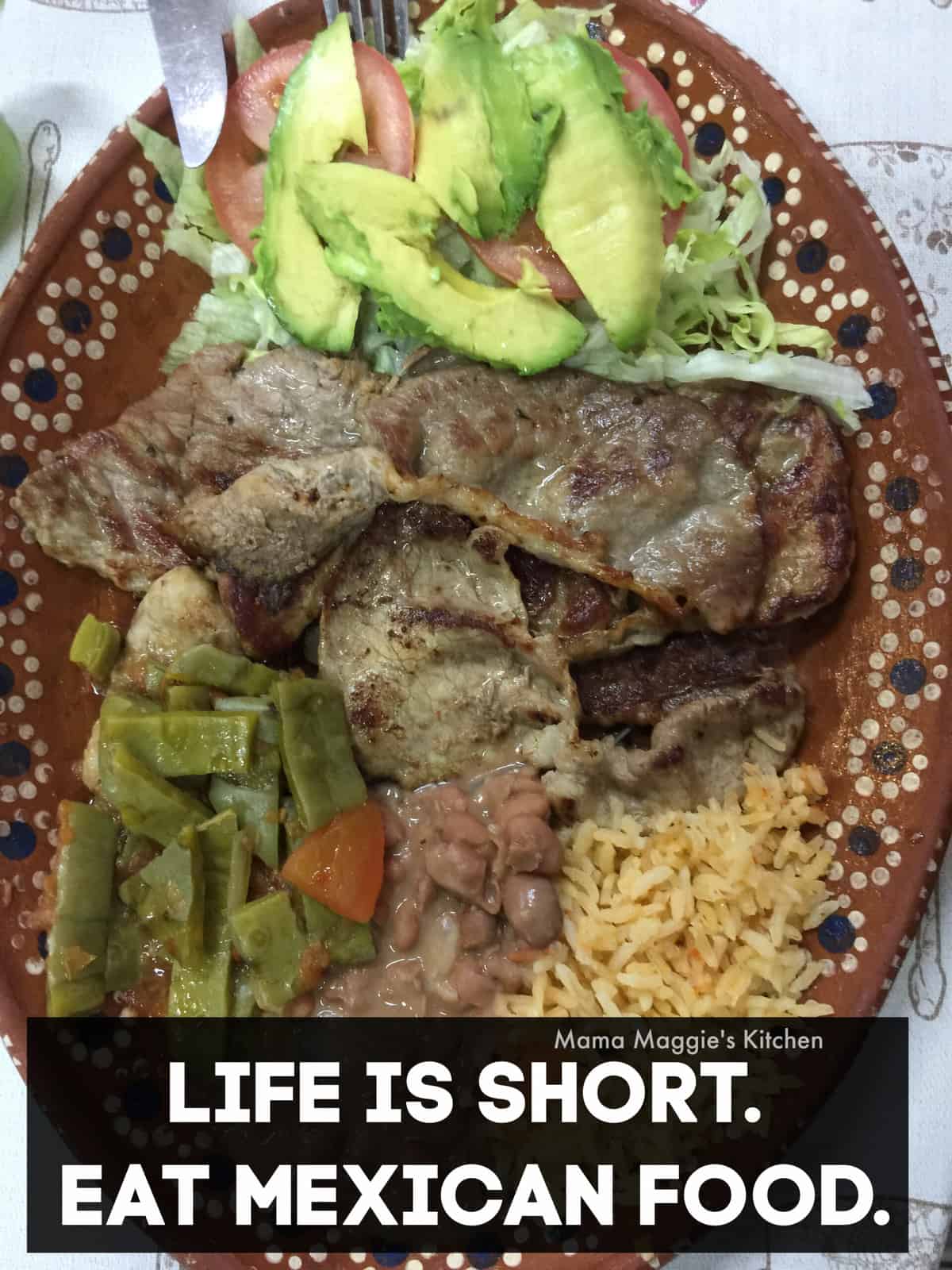 A picture of carne asada served next to rice, nopales, and avocado.