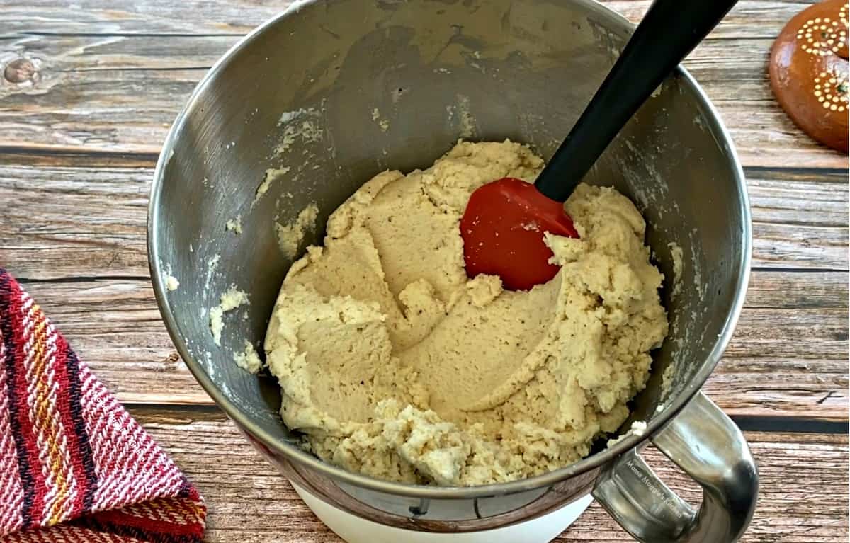 Masa for Tamales in a mixer with a spatula.