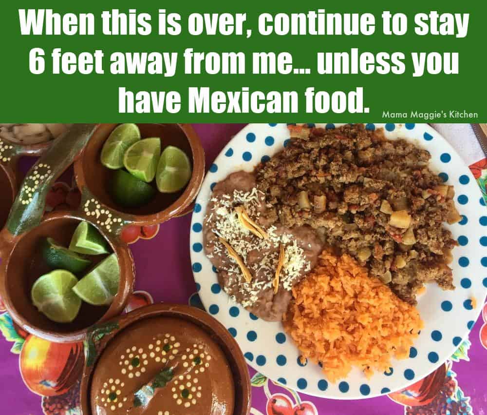 A picture of a plate with picadillo, rice, beans, and lime. 