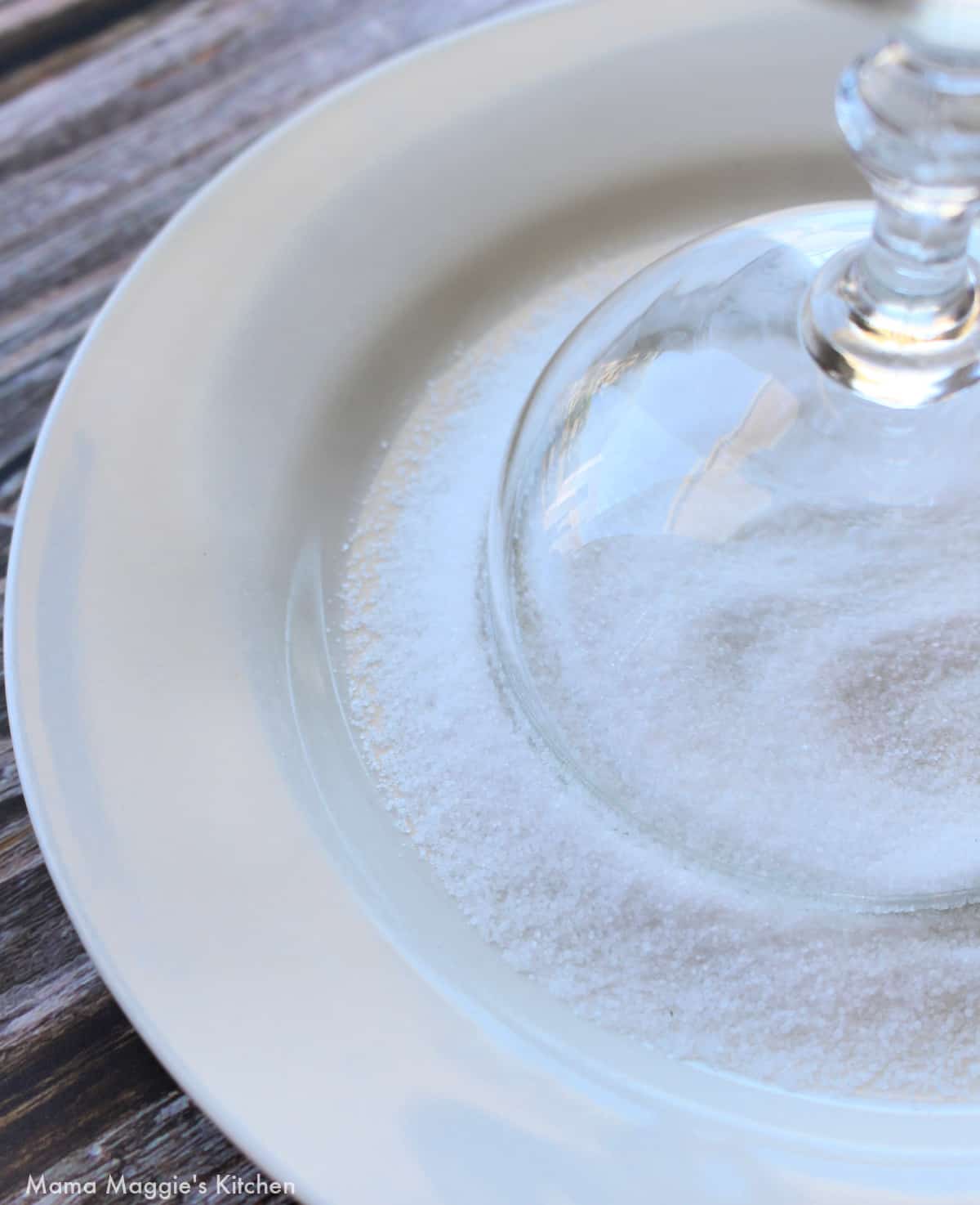 A glass turned upside down on a plate with salt.