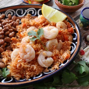 Arroz con Camarones (Mexican Shrimp and Rice) served next to beans and a jalapeno.