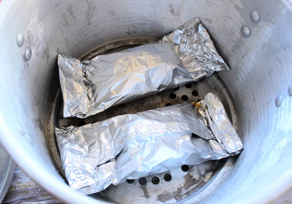 Foil packets in a steamer pot.