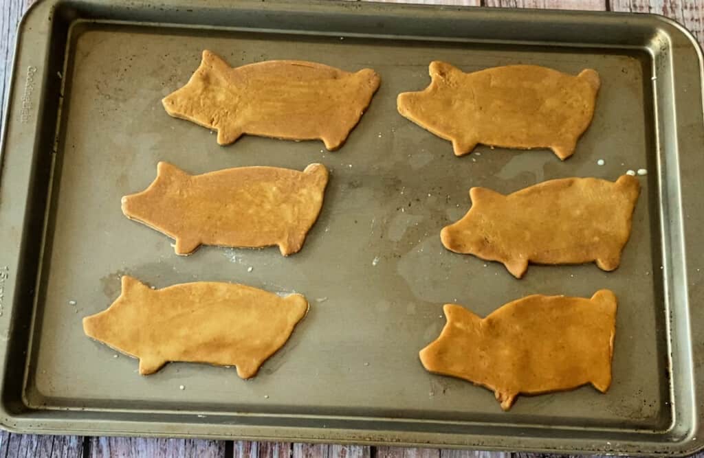 Unbaked marranitos sitting on a sheet pan.