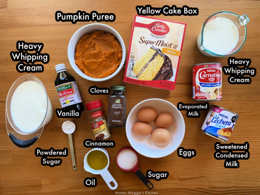 The ingredients needed to make the cake labeled and spread out on a wooden table.
