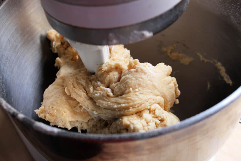 A picture of a KitchenAid mixer forming the dough for the Mexican sweet bread.