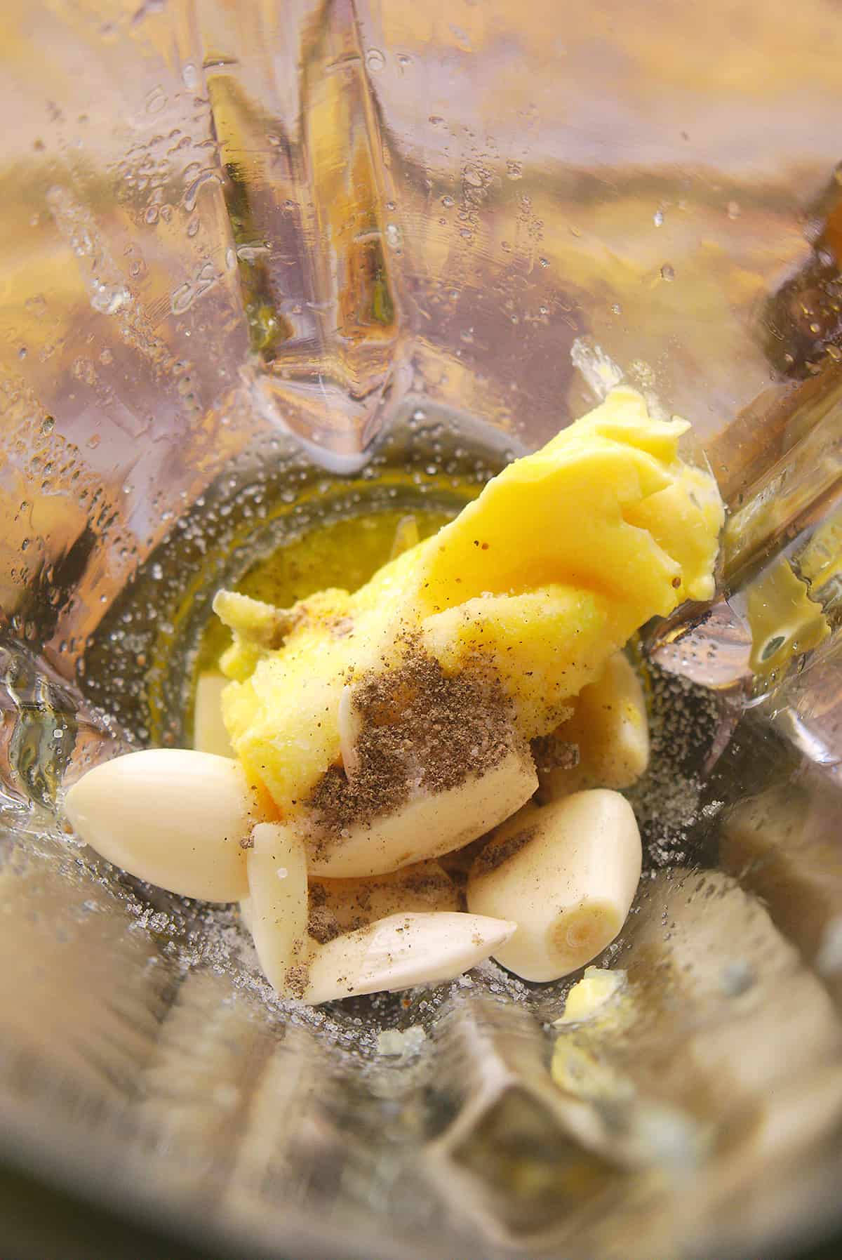 Garlic, pepper and butter in a glass blender