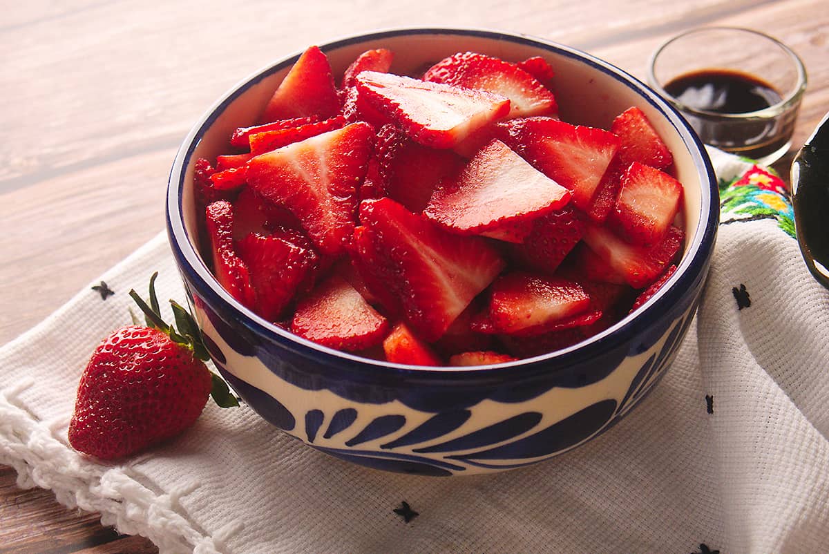 Sliced strawberries served in a bowl.