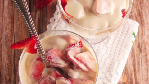 Two cups of Fresas con Crema served in a glass cup.
