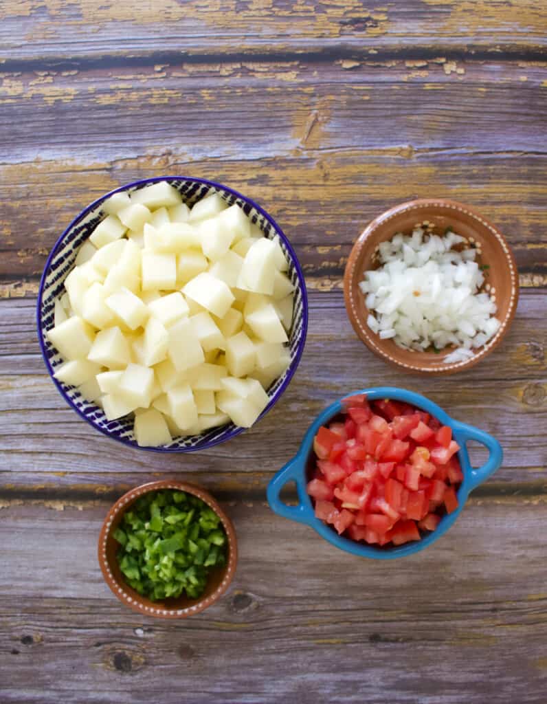 The ingredients needed to make Mexican-style potatoes diced and ready to be cooked.