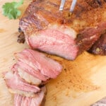 Slices of the grilled tri-tip with Mexican dry rub recipe sitting on a cutting board.