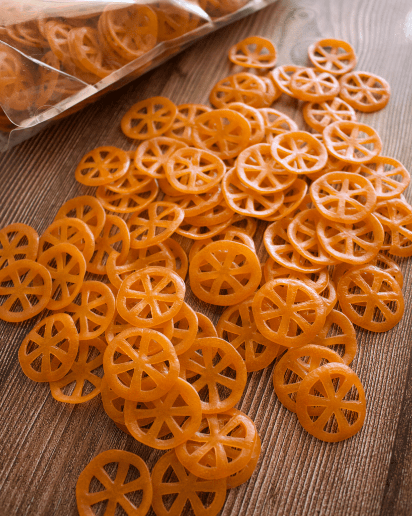 Wheat flour pinwheels sitting on a wooden surface.