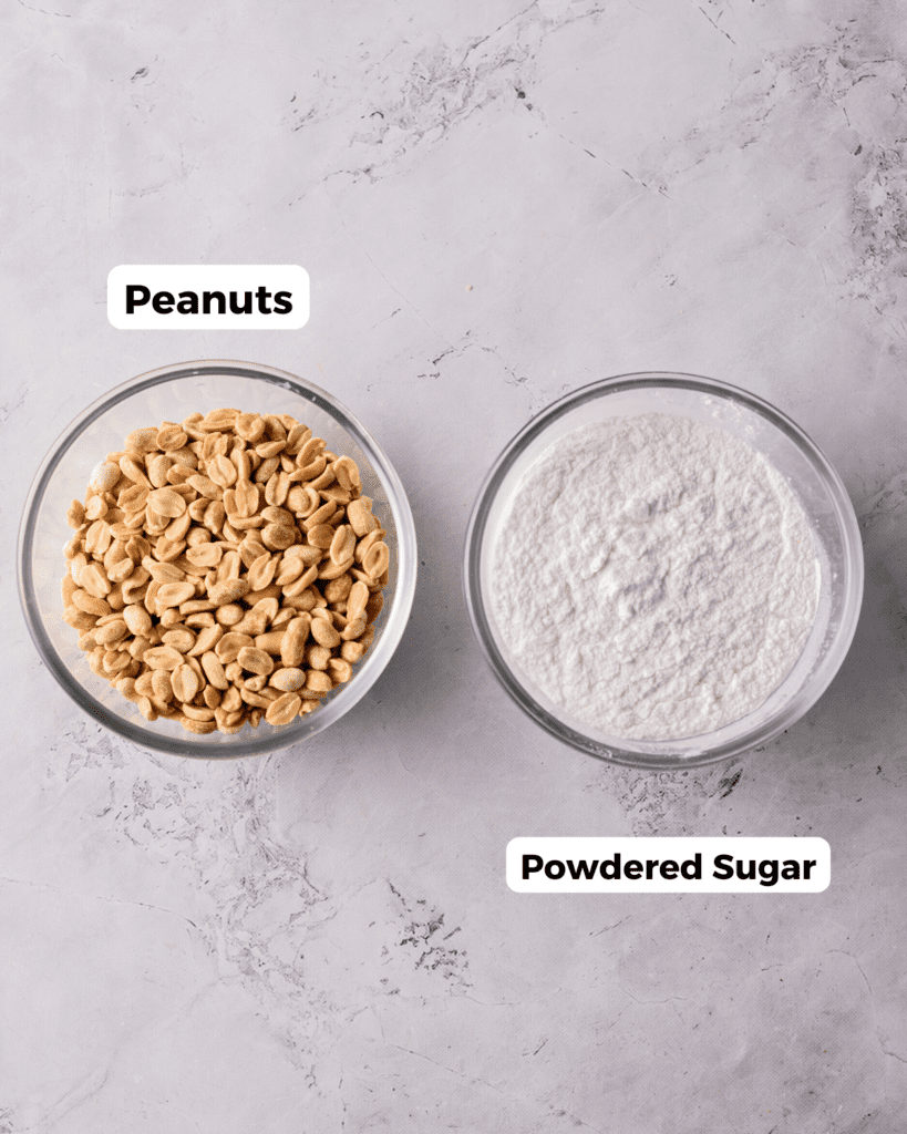 Peanuts and powdered sugar in bowls next to each other.
